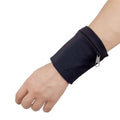 Black adjustable wrist bag with armband, showing zipped main compartment and external card slot on a person's forearm.