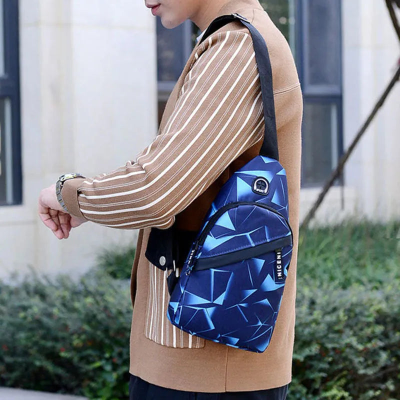 Men's blue print sling chest bag with a visible earphone hole and a single adjustable strap.