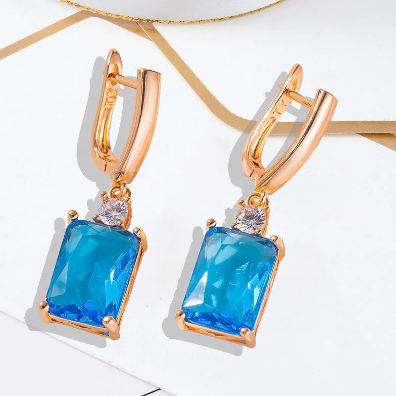A pair of square geometric earrings in gold or silver colour, made from electroplated copper.