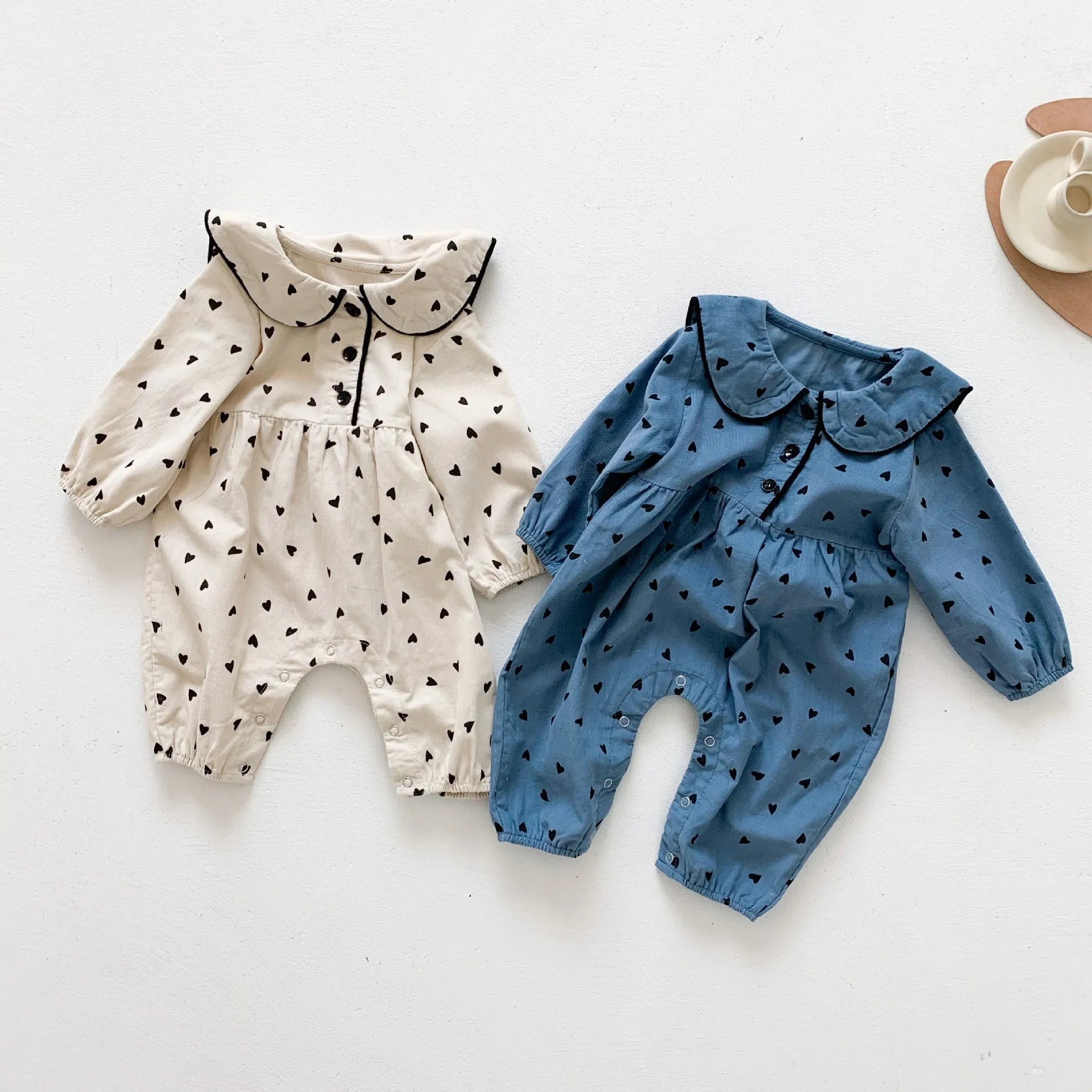 Baby onesie autumn corduroy long sleeve neutral gender beige infant bodysuit on white background
