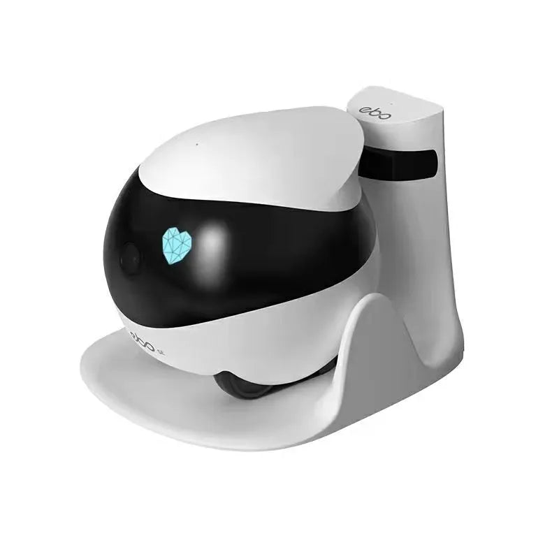 White smart home mobile robot camera with a lens and sensors on a charging dock.
