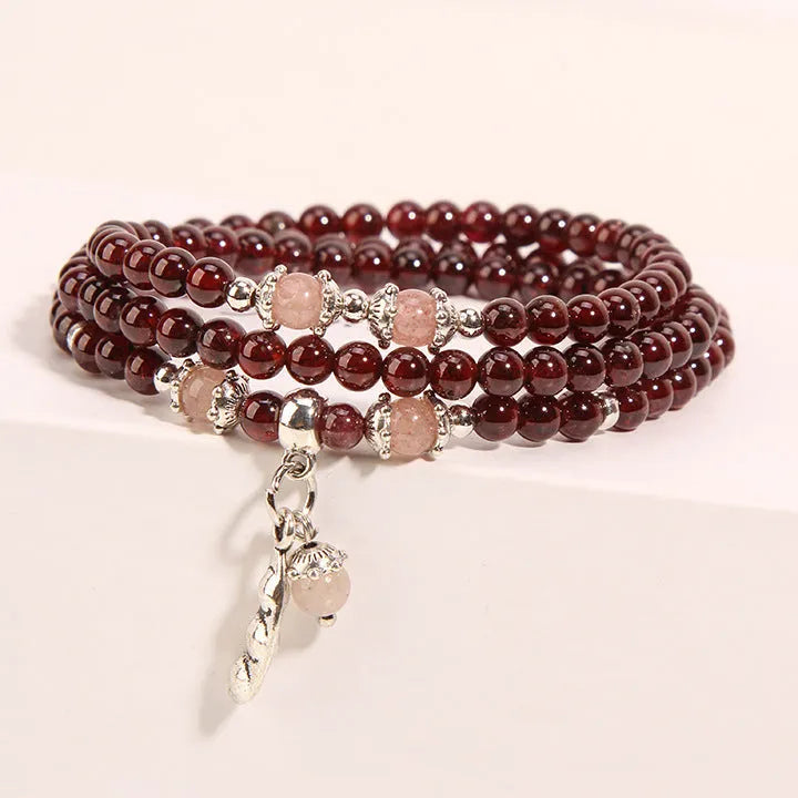 Women's Bohemian style crystal flower bracelet in wine red garnet and sauteed green beans colour.