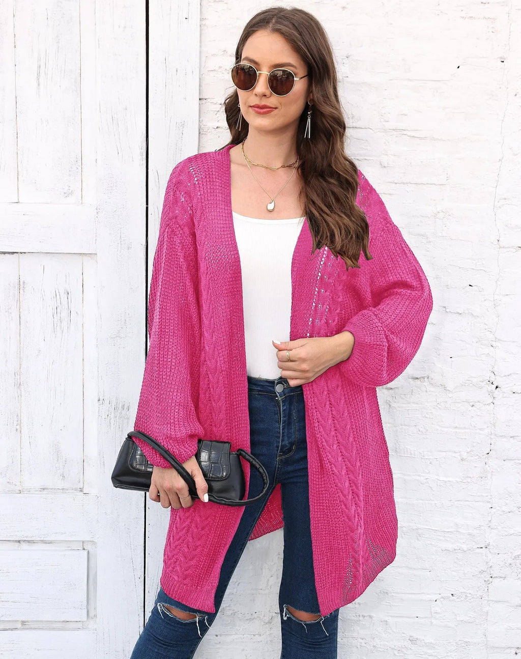 Women's loose longline acrylic cardigan sweater coat in a solid colour.