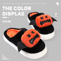 Black Halloween cartoon pumpkin slippers with small wings design on indoor floor