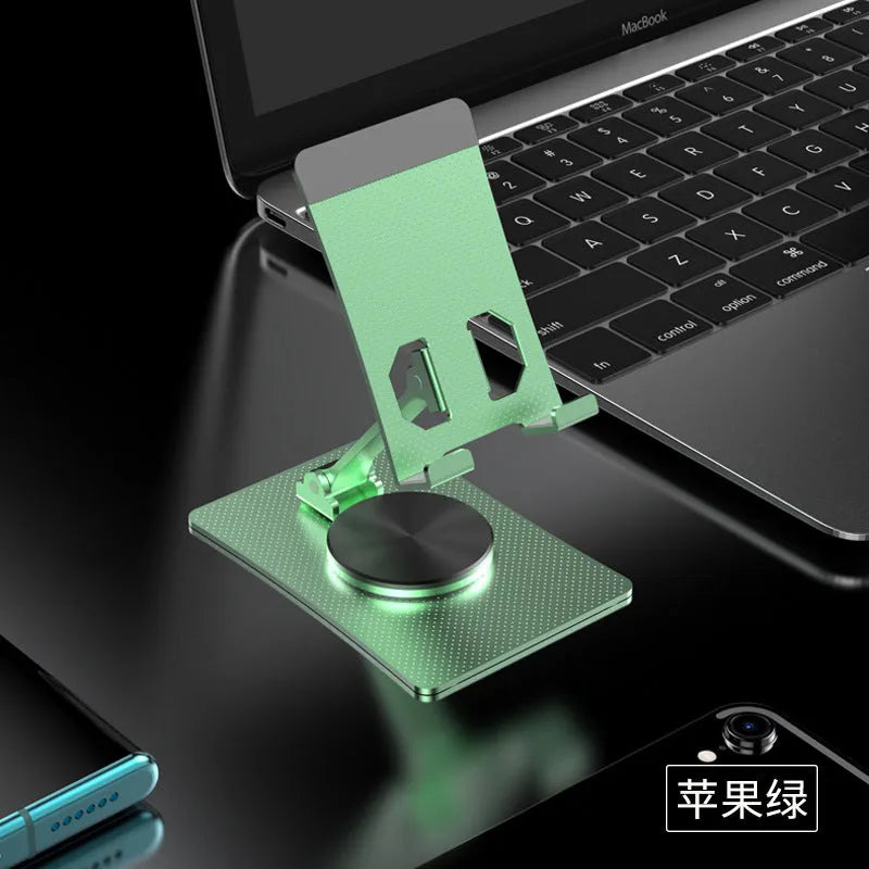 Aluminium alloy rotating mobile phone bracket in silver on a desk, showing three-axis joint and metal texture finish