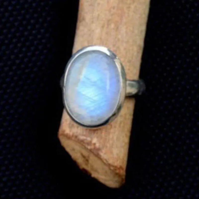 Silver alloy vintage Thai moonstone flower ring for women on plain background