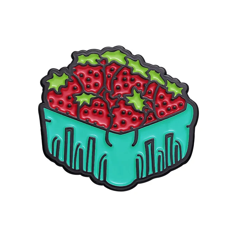 Colourful cartoon-style fruit metal brooch with pin clasp on a denim jacket lapel.