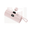 Compact capsule-shaped wireless power bank with digital display and integrated plug, shown in multiple colours.