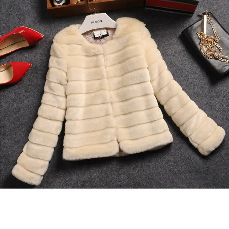 Women's short faux fur top in beige on a hanger, showing regular sleeves and textured fabric.