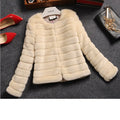 Women's short sleeve faux fur top in beige, shown on a model, showcasing its plush texture and street fashion style.