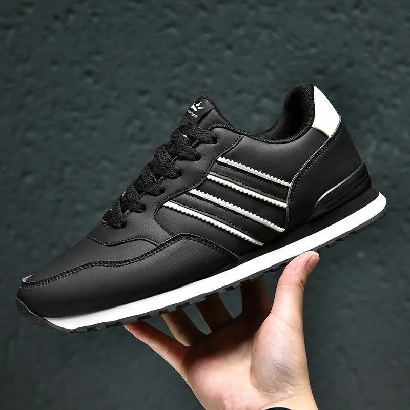 Men's black leather casual sports shoe with carved wing pattern and high heel over 8cm.