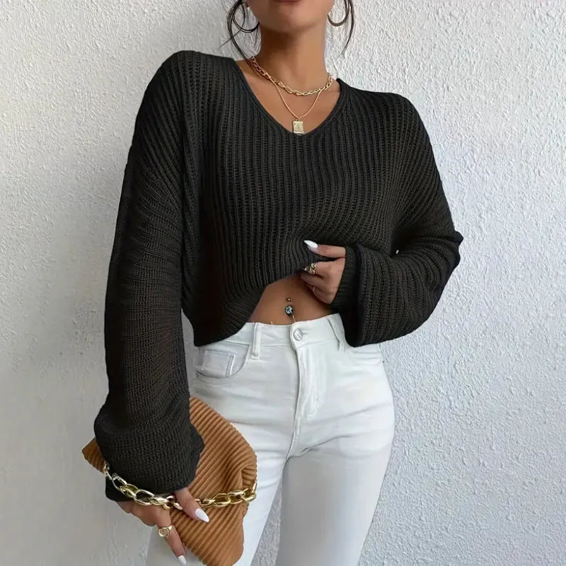 A woman's solid colour long sleeve pullover jumper in a loose, casual fit.