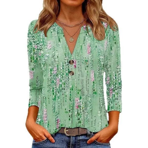 Women's loose-fit V-neck top with a blue 3D geometric pattern print, showcasing front view.