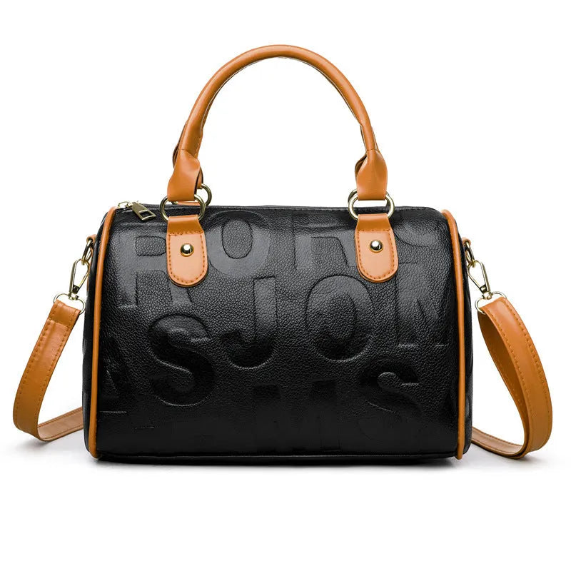 Cylindrical crossbody bag in brown PU leather with three shoulder straps showing textured exterior