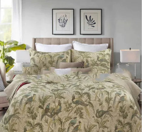 American-style floral quilted cotton bedspread in blue, shown draped on a double bed.