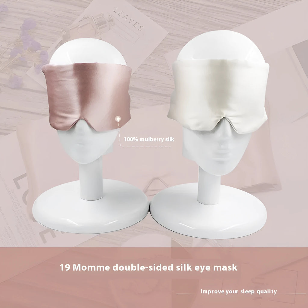 Contoured mulberry silk sleep mask in champagne gold colour, shown resting on a pillow.