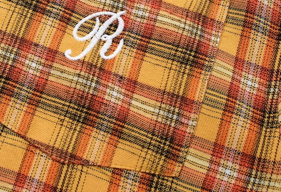 Men's yellow grid plaid short sleeve loose fit shirt on plain background