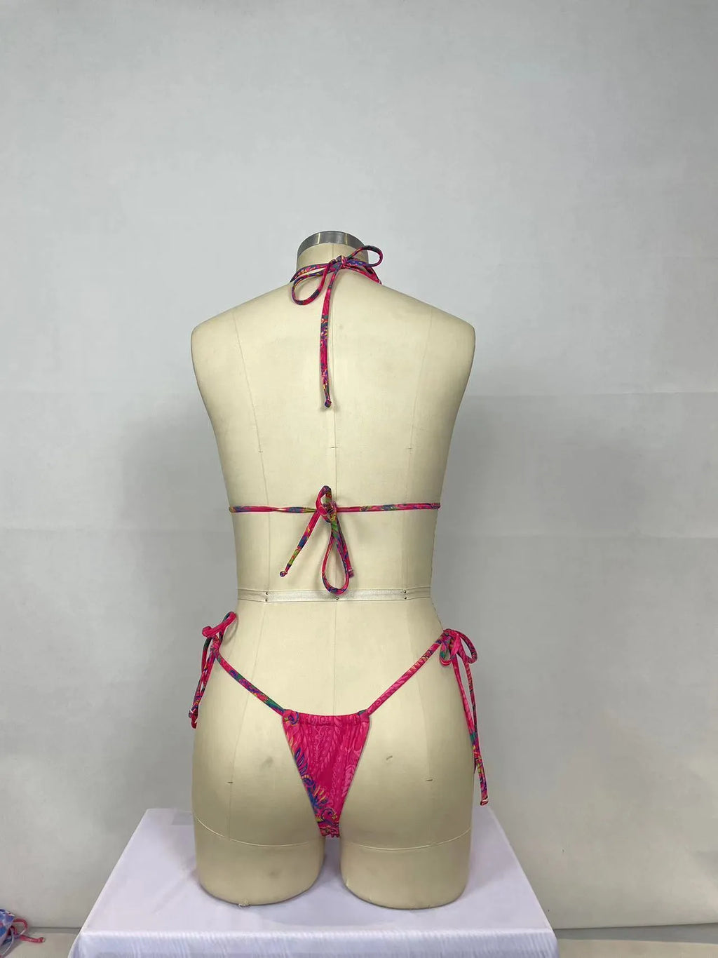 Pink printed women's bikini two-piece set with backless design for swimming.