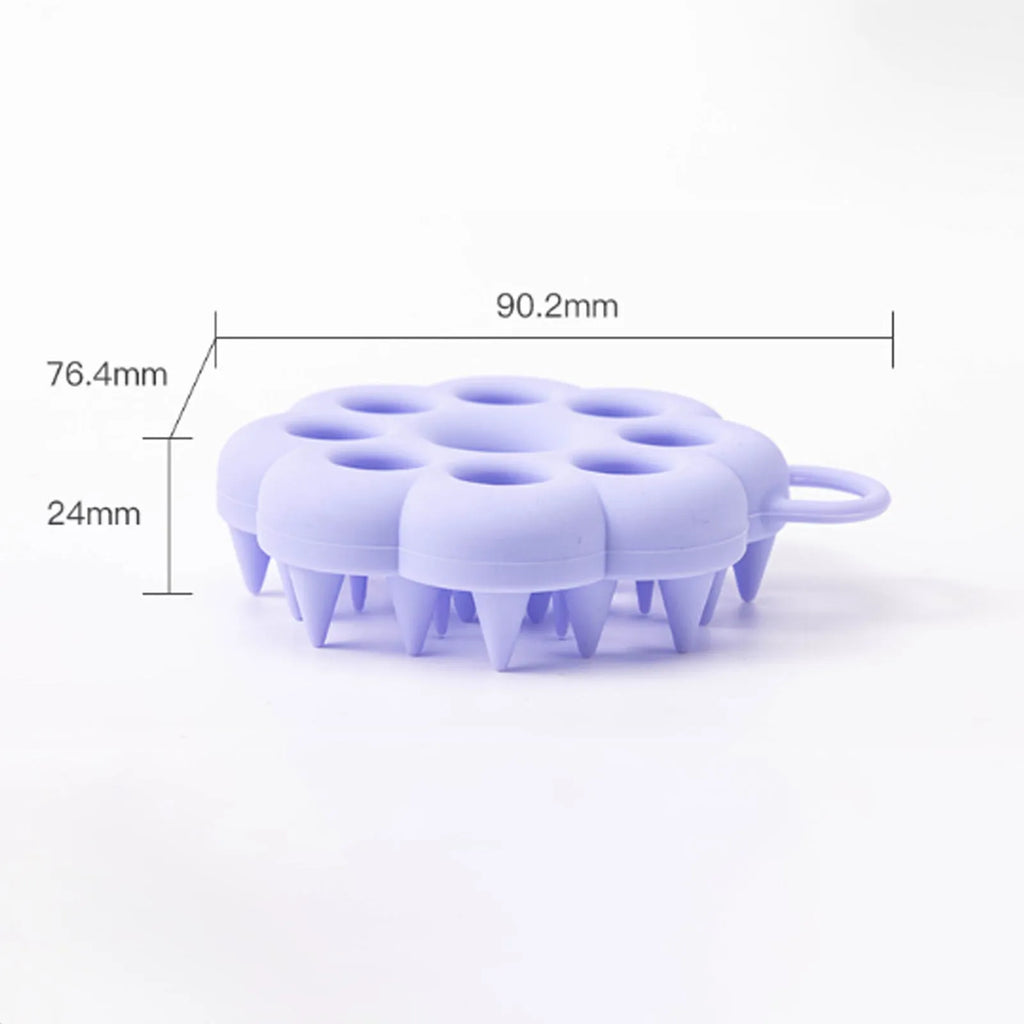 Handheld silicone pet grooming brush for wet and dry use, shown in assorted colours.