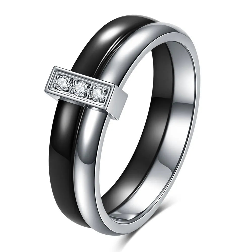Close-up of a women's black ceramic ring with a geometric stitch pattern on a 6mm wide band, showcasing glossy finish.