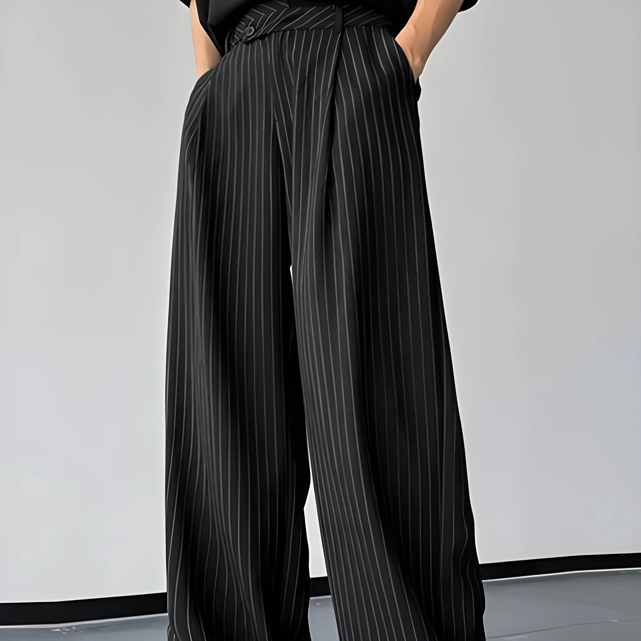 Men's black vertical striped pleated casual trousers showing elastic fabric and Asian sizing options
