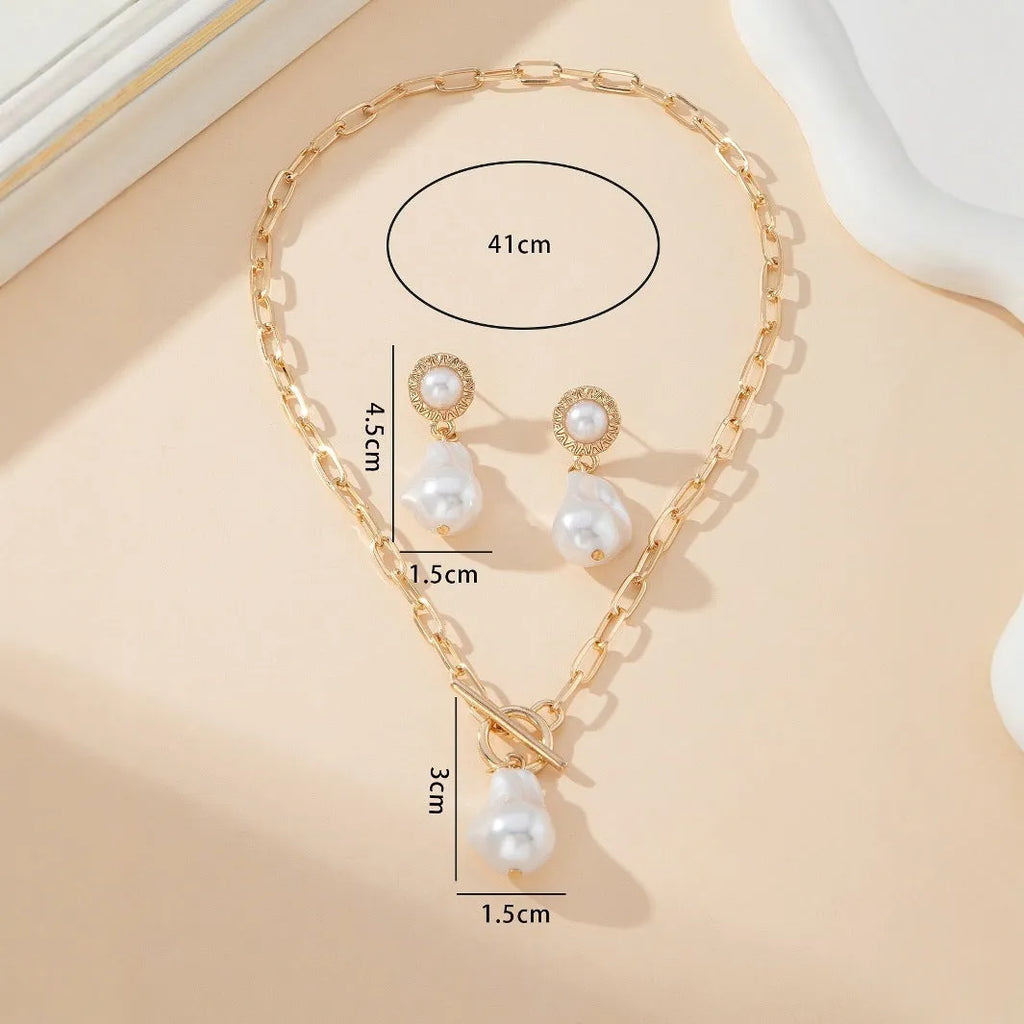 Gold colour baroque pearl pendant necklace and matching stud earrings set.