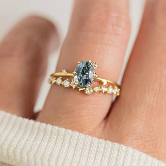 Gold plated floral ring with green zircon stone inlay on a hand, showing side profile and detail.