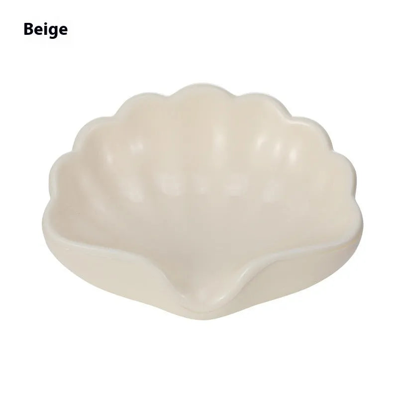 White plastic shell-shaped soap dish for bathroom countertop