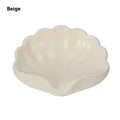 White plastic shell-shaped soap dish for bathroom countertop