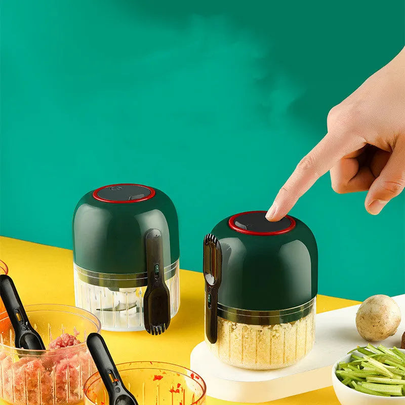 Blue electric garlic masher mini with compact plastic body on kitchen counter