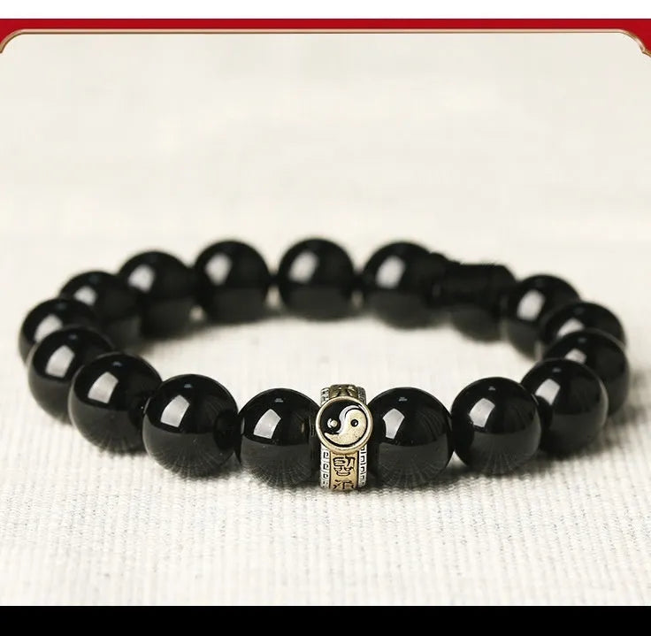 Black stone single ring bracelet for men and women on a wrist, showing 10mm and 12mm size options.