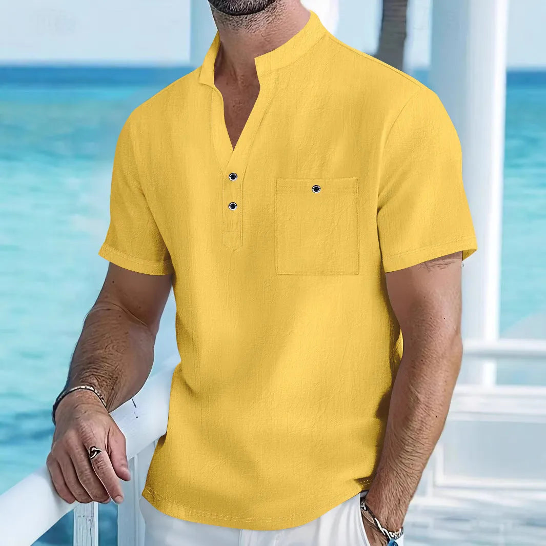Man wearing a loose apricot-coloured linen stand collar T-shirt with short sleeves.