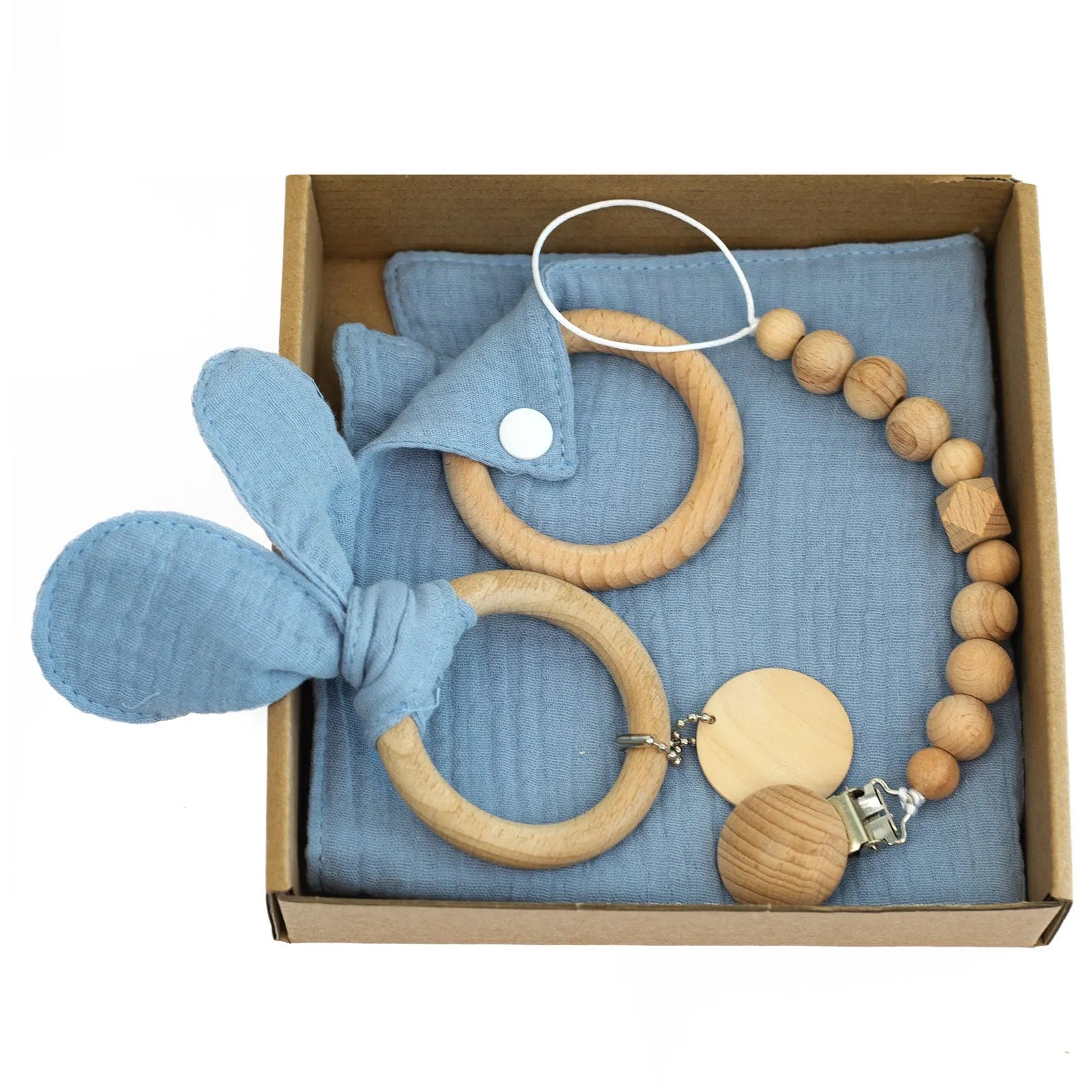 Baby teething toy gift set showing gauze blanket, wooden bell, gum teether, tire brush, and milestone on white background