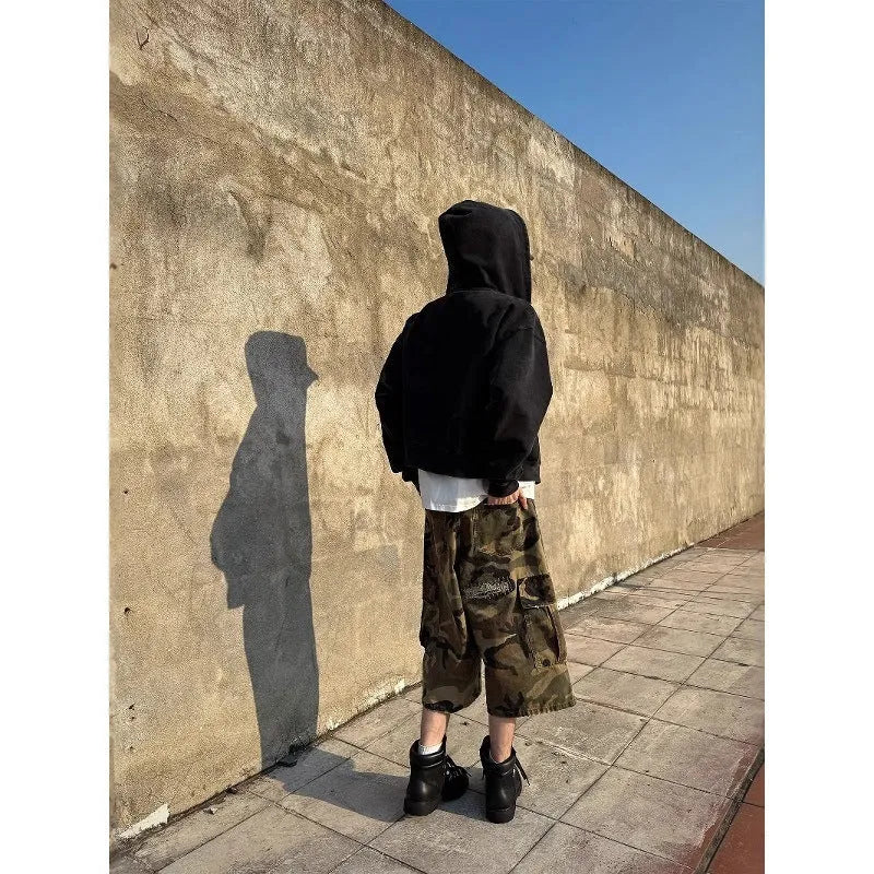 Men's loose straight-leg jeans in camouflage colour with cropped length and distressed patch detailing