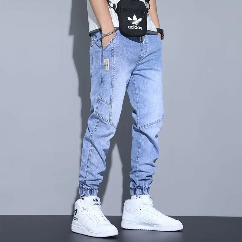 Men's slim fit straight-leg jeans in blue denim with high waist and ankle-tied style