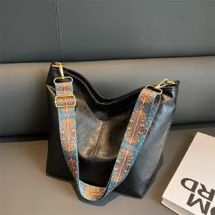 Women's large capacity crossbody bucket bag in PU with nylon lining, available in multiple colours, includes zipper change bag and phone pocket