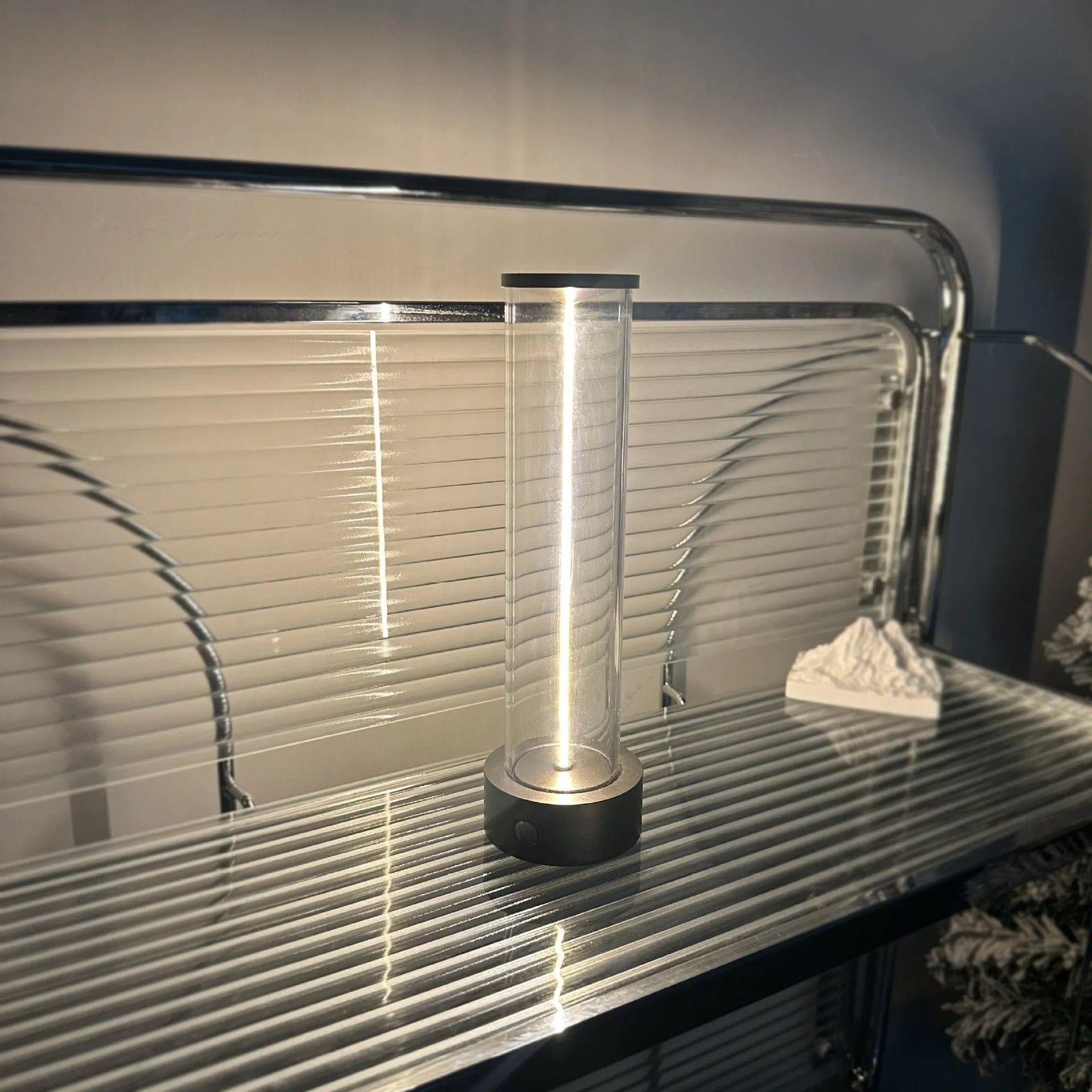 Slender glass LED light strip with magnetic base for USB charging night light.