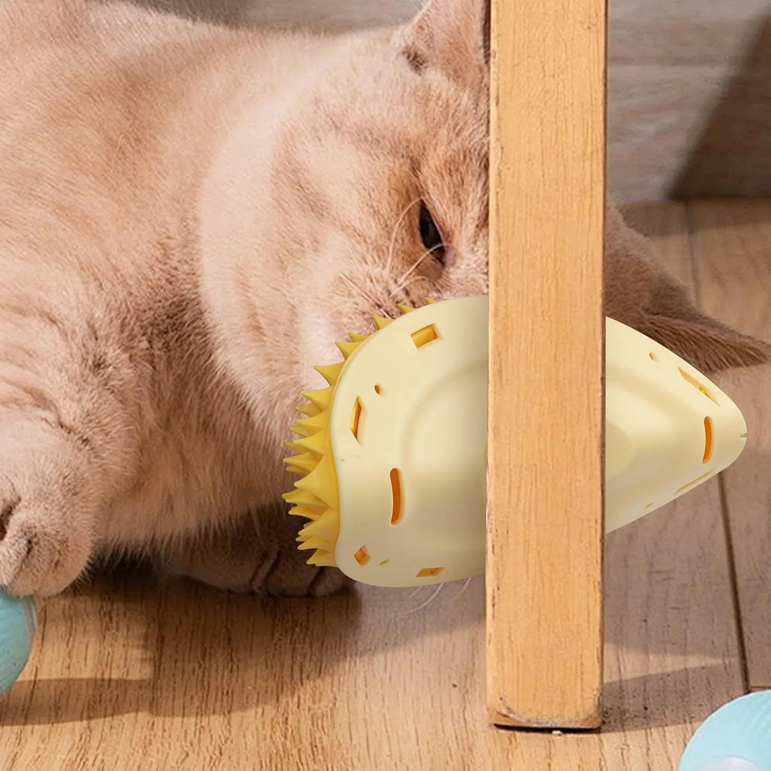 Yellow durian-shaped cat corner scratcher and self-groomer mounted on a wall