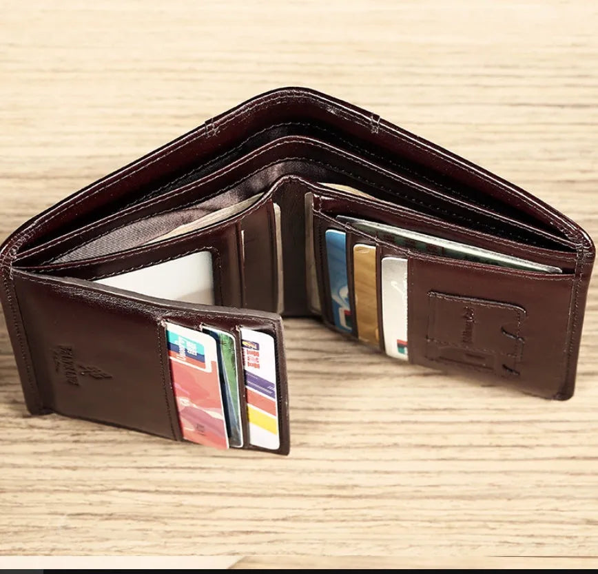 Men's black full-grain leather bifold wallet open, showing eight card slots and a zipped coin pocket.