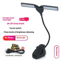 Rechargeable black music stand light with 28 LEDs placed on a music stand.