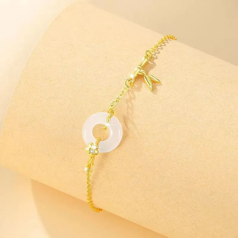 Silver women's bracelet with peace buckle charm, white chalcedony stone, and starry sky design with gold electroplating.