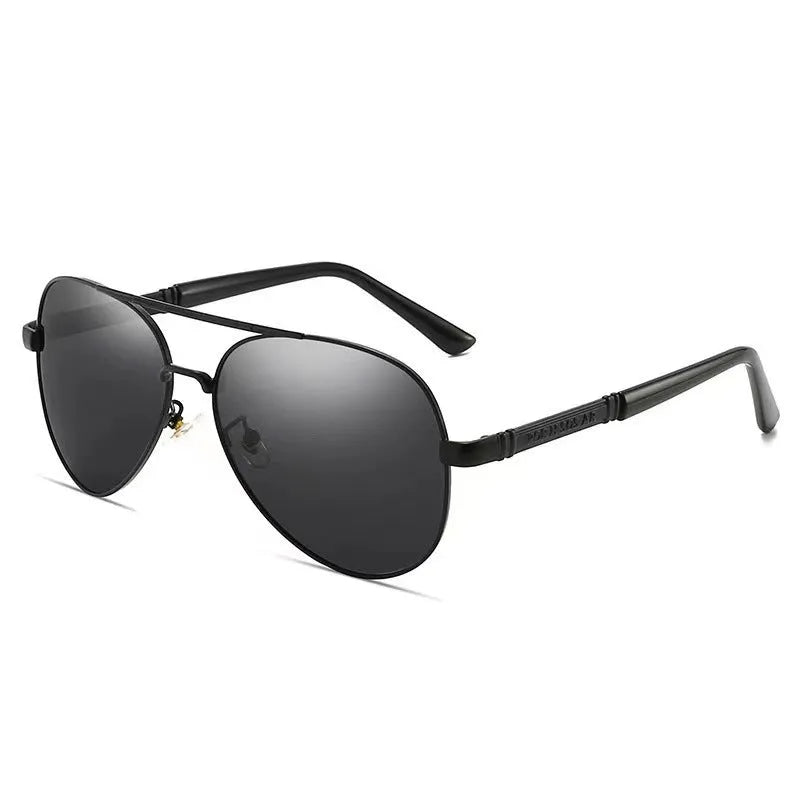 Gold metal frame sunglasses with polarised grey lenses and dragon phoenix temple detail on a table.