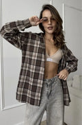 Dark brown striped long sleeve women's shirt with retro style collar on a hanger.