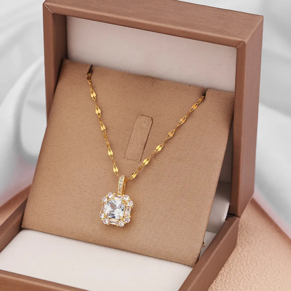 Geometric quadrilateral pendant necklace with mixed gem inlay on a gold titanium steel chain.
