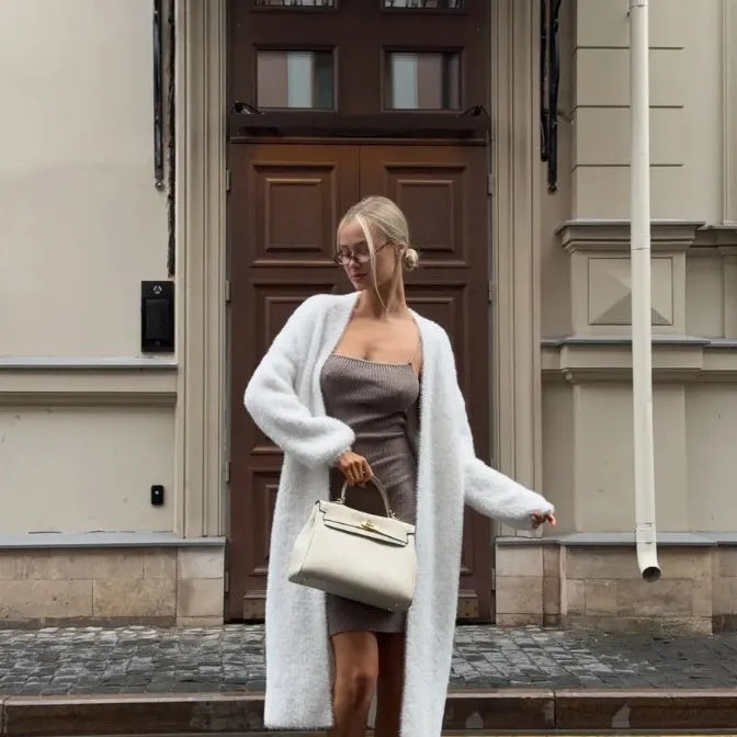 White knitted cardigan jacket for women with long sleeves and a loose fit.