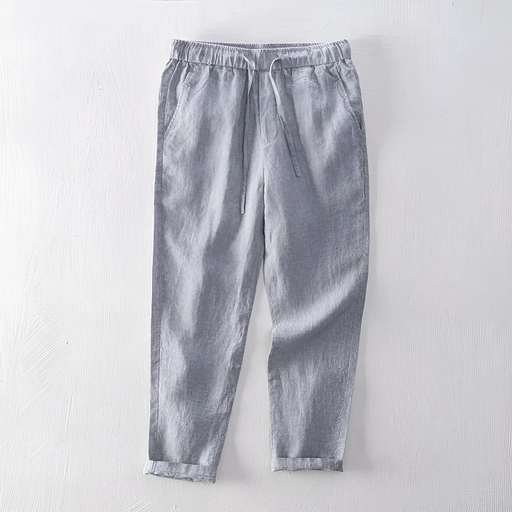 Men's straight leg linen trousers in light grey on a hanger.