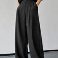 Men's black vertical striped pleated casual trousers showing elastic fabric and Asian sizing options