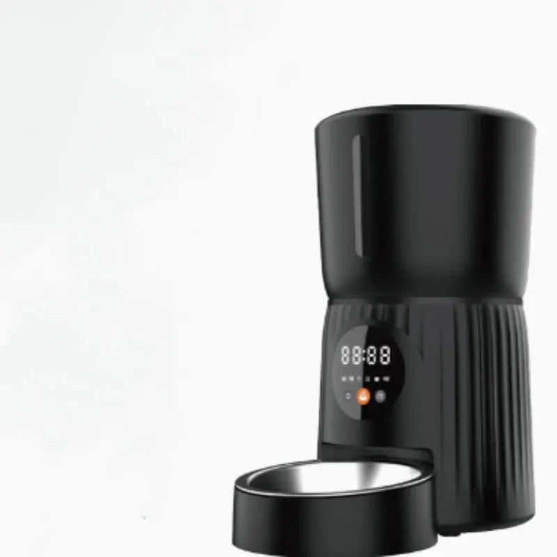Black and white automatic pet feeder with digital timer and USB cable for remote, portion-controlled feeding.