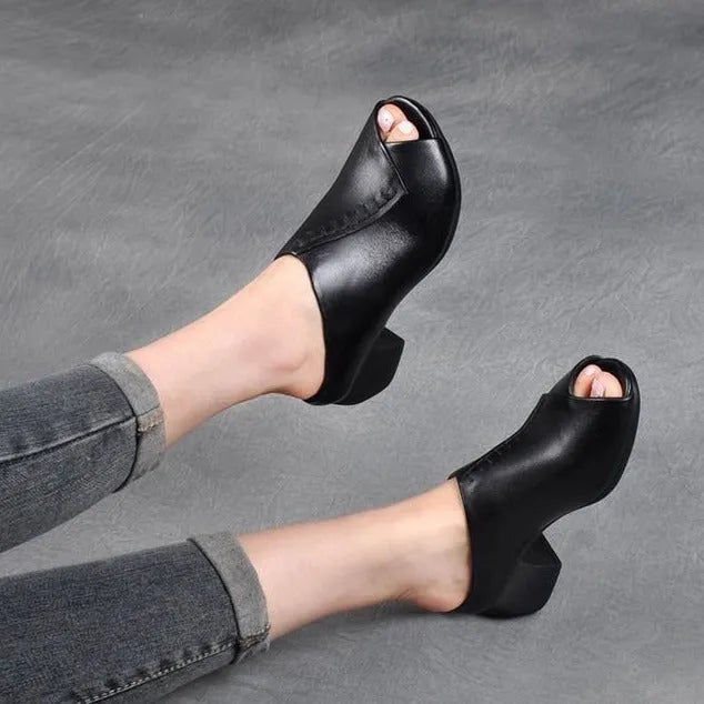 A pair of women's black square heel peep-toe slippers with an open fish mouth design.