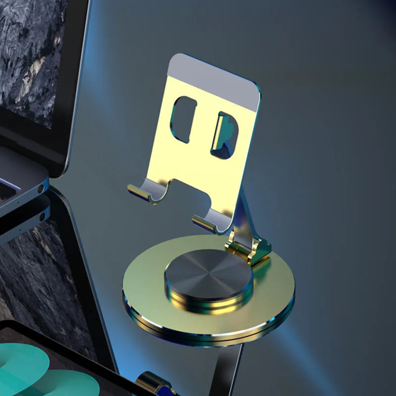 Aluminium alloy rotating mobile phone bracket in silver on a desk, showing three-axis joint and metal texture finish